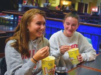 Students eating popcorn in the Davis Cafe