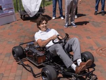 a young white man drives a go kart